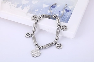 Detailed view of silver clover bracelet with sparkling diamonds and adjustable cord