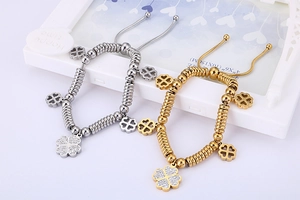 Detail of adjustable four-leaf clover bracelet with white crystals and sliding clasp