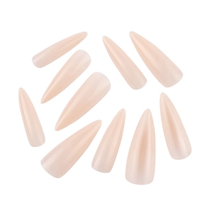 Close-up of nude pink stiletto false nail tips with a glossy translucent finish