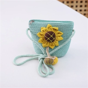 Detail of cute straw crossbody bag for girls with sunflower and green weave texture
