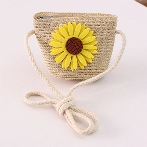 Detail of kids straw crossbody bag featuring yellow sunflower felt decor and zipper