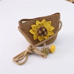 Close-up of a straw woven bag for girls featuring a large yellow sunflower and zipper