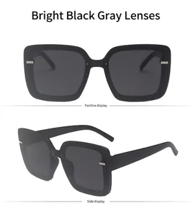 Detail of glossy black square sunglasses with grey lenses and metal bar accents