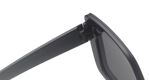 Detailed macro view of the sturdy metal hinge connecting the black square sunglasses frame