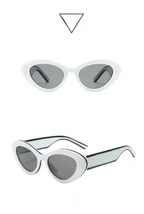 Détail de lunettes de soleil œil-de-chat blanches avec étoiles dorées et branches bicolores