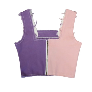 Detail of color-block denim vest with zipper closure and raw fringe edges in purple and pink