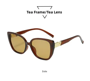 Detail view of tea brown oversized sunglasses with elegant gold V-shape metal hinge logo