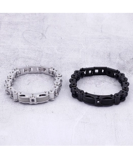 Close-up of titanium steel motorcycle chain bracelets in silver and black with rhinestones
