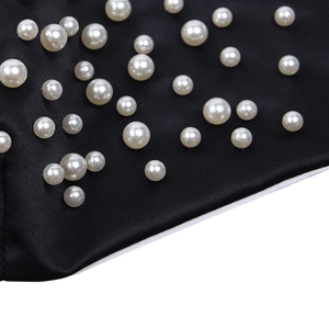 Fashionable black face mask featuring decorative white pearls with adjustable ear loops