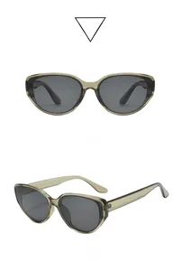 Close-up of translucent green cat-eye sunglasses with dark gray lenses at a 45-degree angle