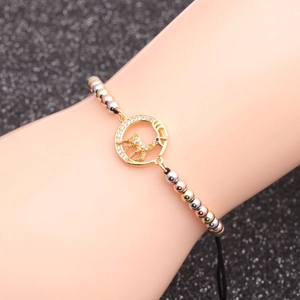 Three-tone beaded chain bracelet featuring a micro-pave zircon deer pendant on model wrist