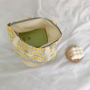 Top view of floral cotton handbag showing internal capacity with a green lunch box