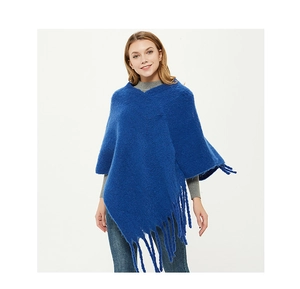 Detailed view of the dark blue mohair textured knit poncho with frayed fringe hem