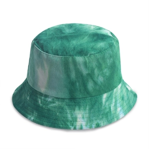 Macro shot of vertical ribbed corduroy texture on green and white tie-dye bucket hat