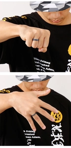 Men's punk style stainless steel ring with black and white stripes worn on a hand
