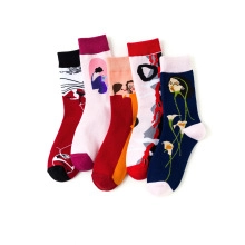 Detailed close-up of five colorful socks featuring unique artistic planet embroidery