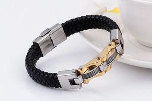 Close-up of black braided leather bracelet with silver and gold metal magnetic clasp