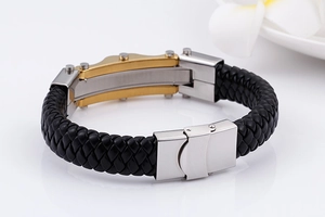 Macro shot showing black braided leather texture and silver-gold stainless steel buckle