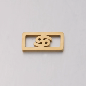 Detailed view of a gold stainless steel Cancer zodiac charm for DIY jewelry making