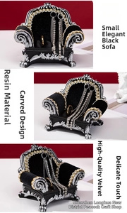 Detailed views of a miniature black sofa jewelry display with silver carved resin details