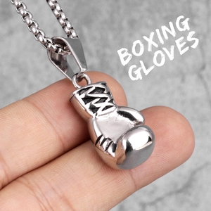 Polished stainless steel boxing glove pendant necklace with a detailed embossed texture