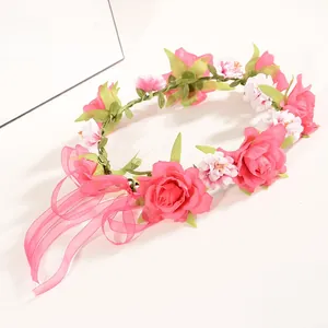 Detail of red and white artificial roses on an elastic headband with pink organza ribbon