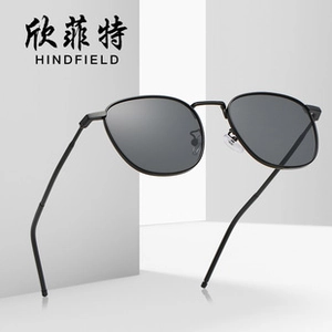 Detail view of lightweight black metal frame sunglasses with dark grey polarized lenses