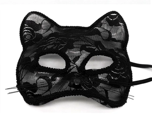 Detail of a black lace cat mask with faux gem and synthetic whiskers for cosplay party