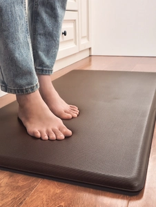 Detailed view of dark brown PU leather kitchen mat with non-slip texture and beveled edge