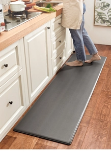 Thick anti-fatigue PU leather kitchen mat with non-slip texture on wood floor
