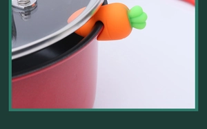 Silicone carrot pot lid lifter prevents boiling over on red cookware edge