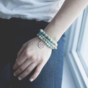 Three-layer natural stone bead bracelet with a silver lotus flower pendant detail
