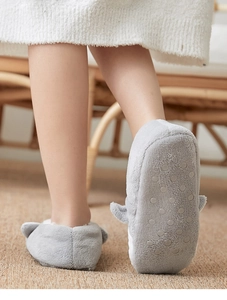 Detail of grey shark slippers showing non-slip silicone grips on sole for safety