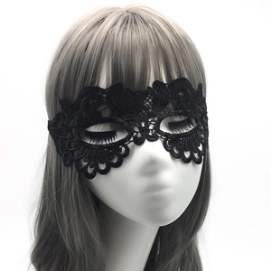Close-up of black lace masquerade mask with intricate floral embroidery for parties