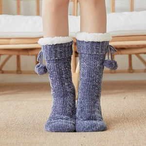 Blue cable knit thermal floor socks with white faux fur lining and pompom ties