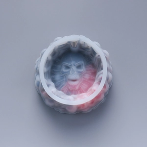 Macro view of the skull resin mold with detailed 3D carving and red-blue gradient silicone