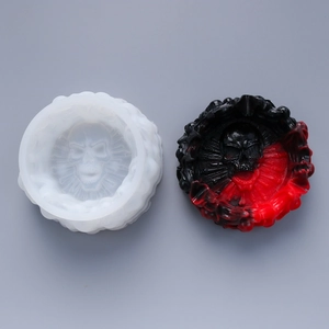 Detail view of a skull themed DIY silicone mold with a black and red resin finished product