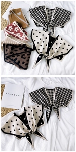 Flat lay of knitted shawls featuring houndstooth, polka dots, and leopard patterns