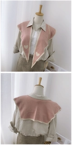 Pink knitted shawl with cream heart pattern and ruffle trim shown on a mannequin