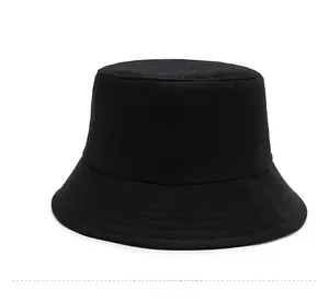 Detail of a minimalist black cotton bucket hat showing parallel stitching on the brim