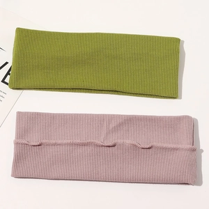 Detail of olive green and dusty pink ribbed cotton knit headbands with soft texture