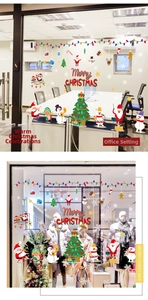 Detail of Santa and Snowman Christmas window stickers on glass storefront with Merry Christmas text