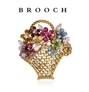 Macro view of flower basket brooch featuring colorful rhinestones and gold texture
