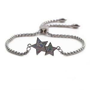 Macro detail of silver star pendants with colorful micro-pave cubic zirconia on bracelet