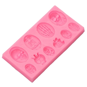 Pink silicone mold with ten skeleton and bone shapes for Halloween baking and crafts