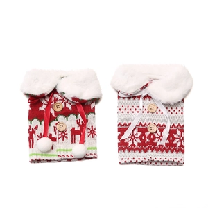 Detail of knitted Christmas wine bottle covers with elk patterns and wooden buttons