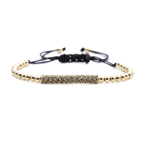 Gold beaded bracelet with black micro-pave cylinder and adjustable nylon string