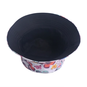 Close-up of bucket hat with butterfly print featuring black inner lining and wide brim