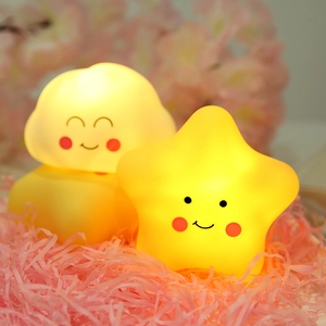 Cute star and cloud night lights with warm yellow glow on pink decorative background