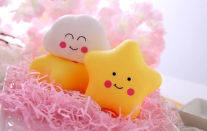 Close-up of cute silicone night lights in star and cloud shapes with smiling faces